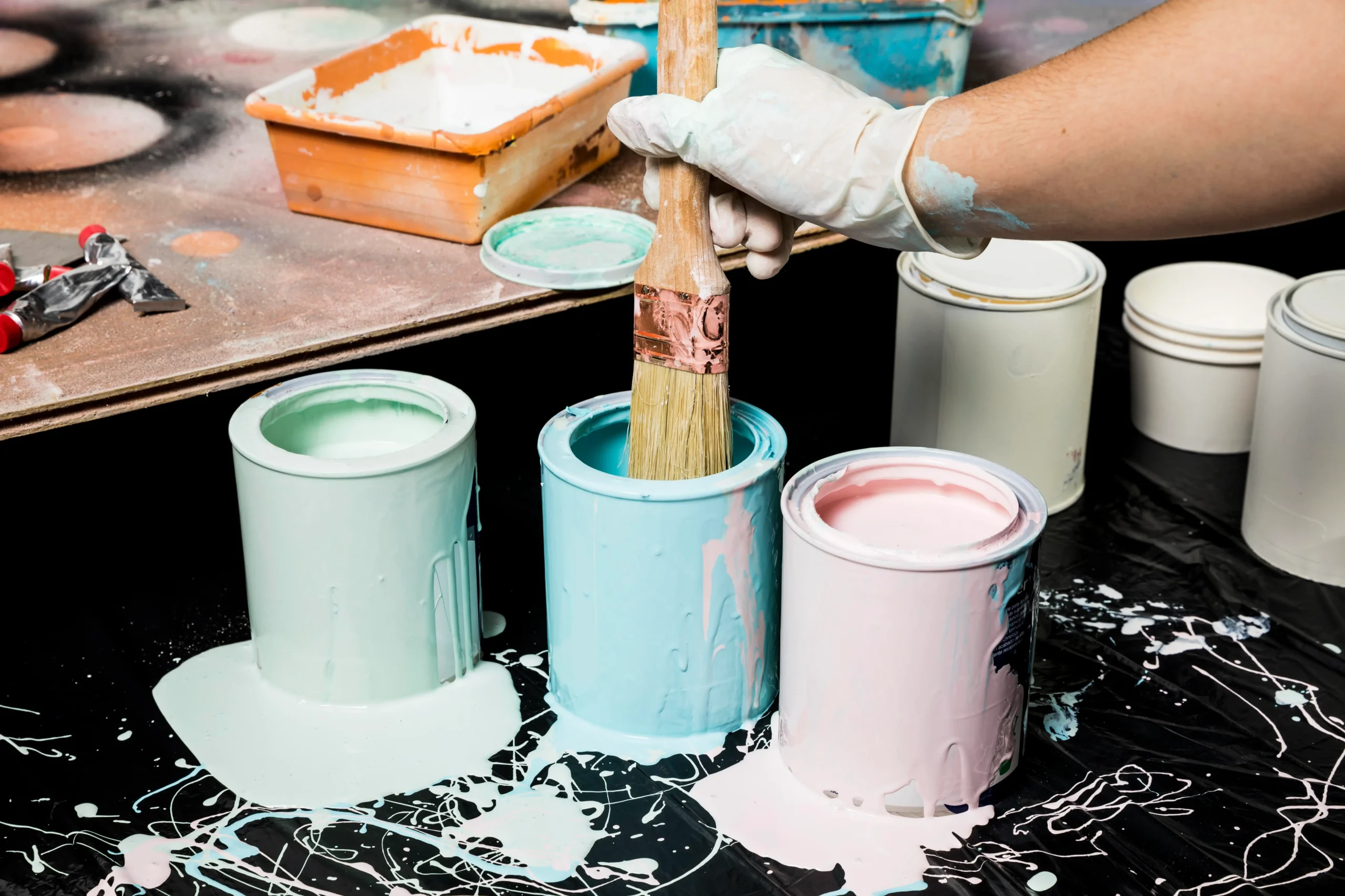 artist using paint from cans 1 scaled
